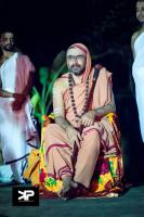 Swamiji keenly watching the tiger dance during the Mrigbete Utsav